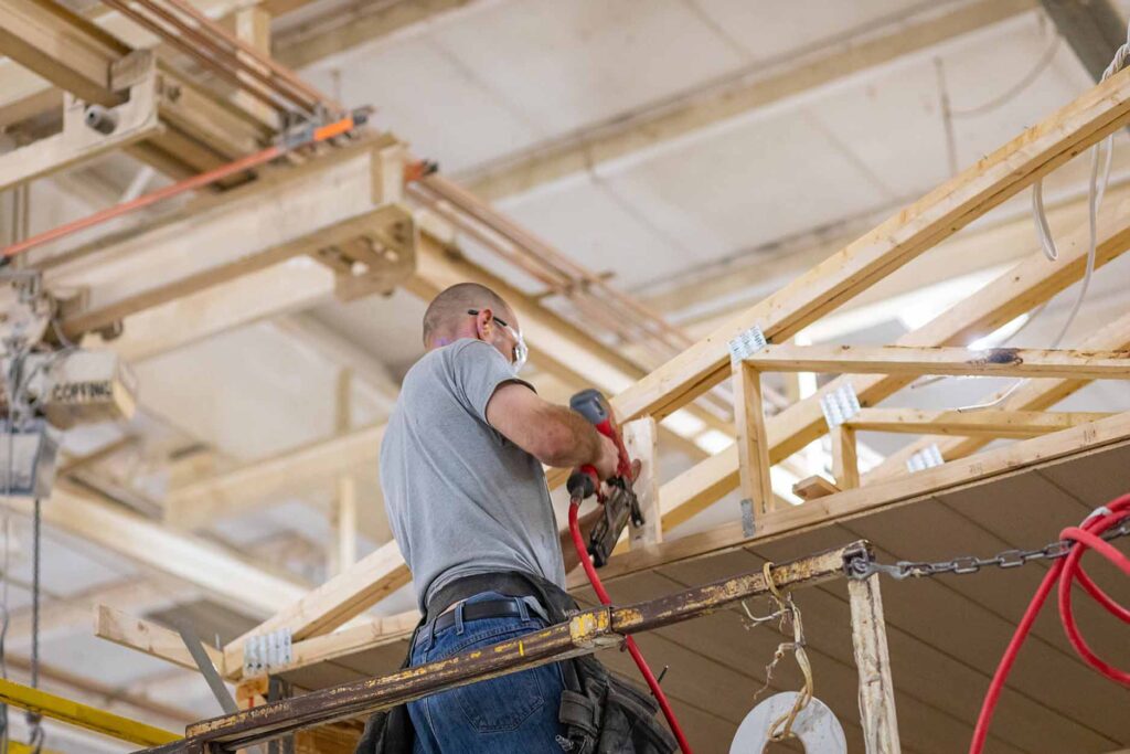 Fleetwood Homes manufacturing employee securing roof rafters